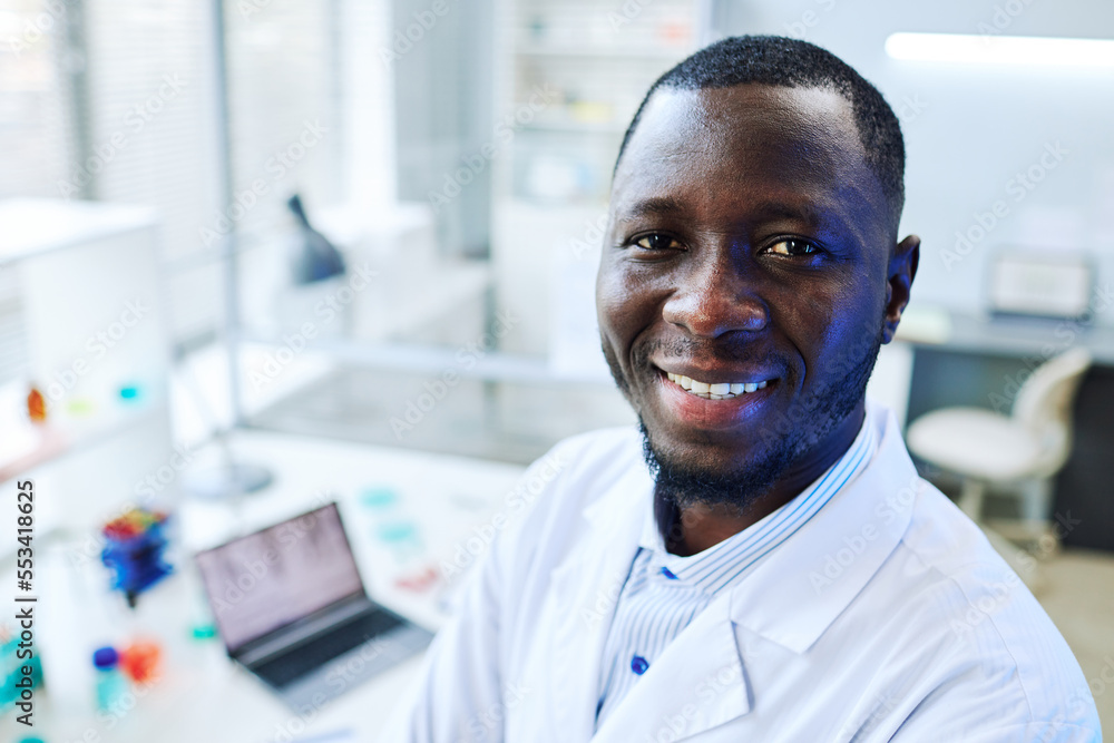 Close up portrait of smiling black man looking at camera in medical laboratory, copy space Close up portrait of smiling black man looking at camera in medical laboratory, copy space