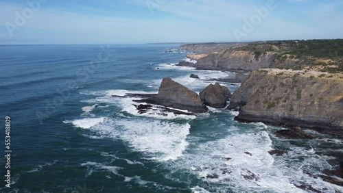 cliffs by drone, in odeceixe portugal, sun and blue sky photo