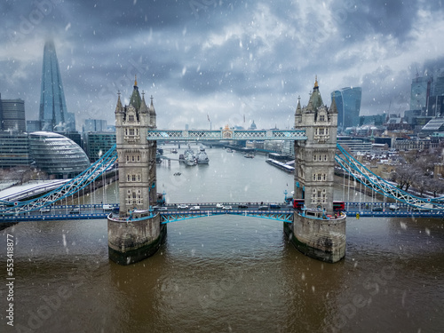 Aerial view of the Tower Bridge in London, England, with snow and ice during winter time