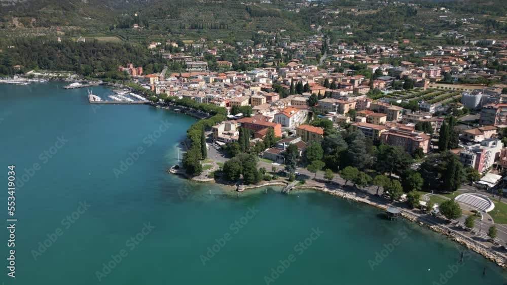Establishing fly away shot of Garda Town, by the Lake Garde in Italy. Cinematic, Establishing shot. Holiday, tourism and travel. Establishing fly away shot of Garda Town, by the Lake Garde in Italy. Cinematic, Establishing shot. Holiday, tourism and travel.