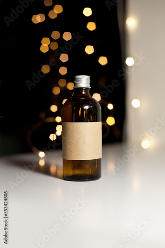 One cosmetic dark amber glass bottle with kraft paper label, minimalism brand packaging mock up