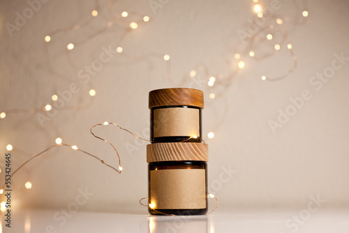 Two cosmetic dark amber glass jars with kraft paper label, minimalism brand packaging mock up