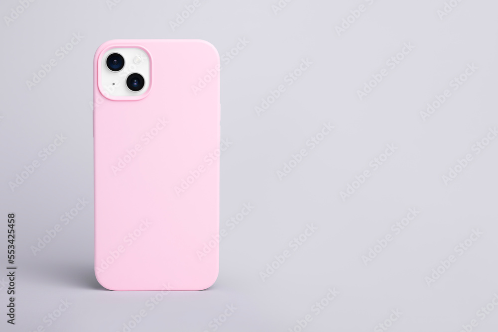 high quality starlight color iPhone 14 Plus in pink case isolated on gray background back view, Banner with place for text on the right, smartphone cover mock up high quality starlight color iPhone 14 Plus in pink case isolated on gray background back view, Banner with place for text on the right, smartphone cover mock up
