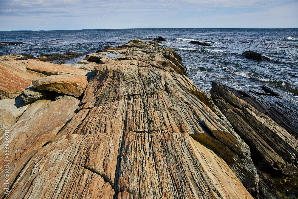 Ocean coast of Maine with layered rocky terrain in sheets Ocean coast of Maine with layered rocky terrain in sheets