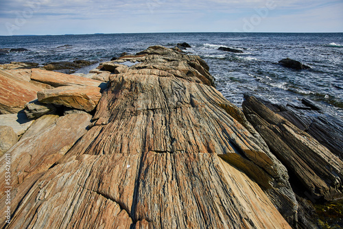 Ocean coast of Maine with layered rocky terrain in sheets