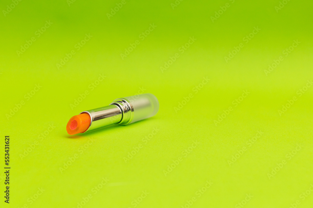 Green lipstick on green background, monochrome Green lipstick on green background, monochrome