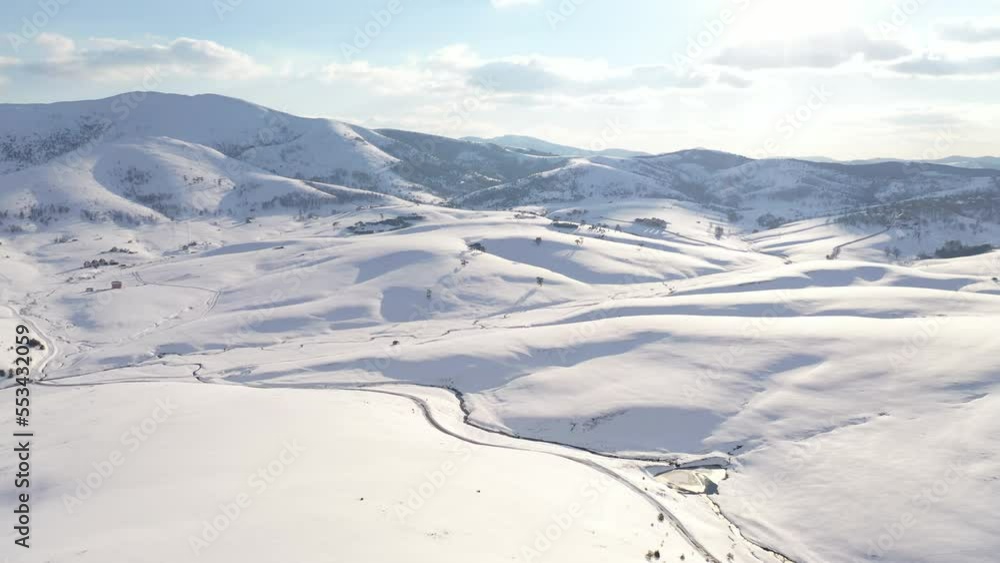 Aerial shot of snow-capped mountain hill in winter at Zlatibor, Serbia from drone pov. Aerial shot of snow-capped mountain hill in winter at Zlatibor, Serbia from drone pov.