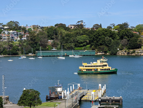 Photography A view of a traditional ferry passing Elkington Park and the harbourside houses in Balmain, from Cockatoo Island, Sydney, NSW, Australia