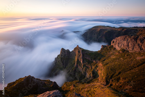 Beautiful sunrise over the sea of clouds. View of the rocks and peaks of Madeira Island, Portugal © VOJTa Herout