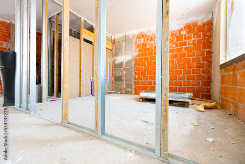 Frame for plasterboard wall, mounted vertical metal and wooden profiles, work in progress of unfinished edifice