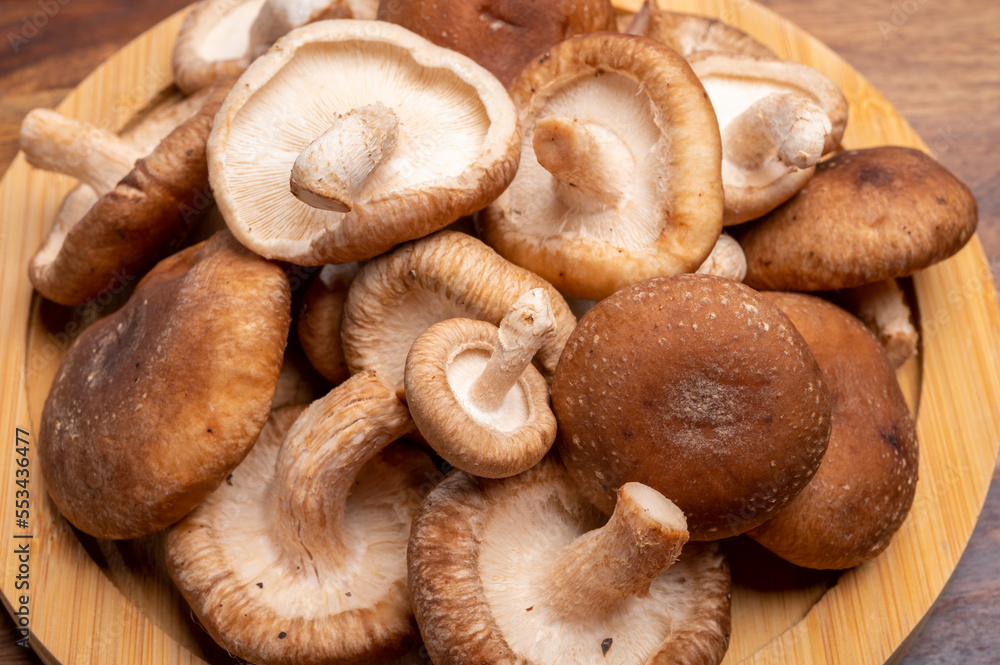 Fresh brown Lentinula edodes or shiitake edible mushrooms Fresh brown Lentinula edodes or shiitake edible mushrooms