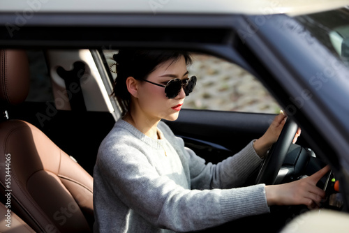 Asian woman driving in black sunglasses © jeson