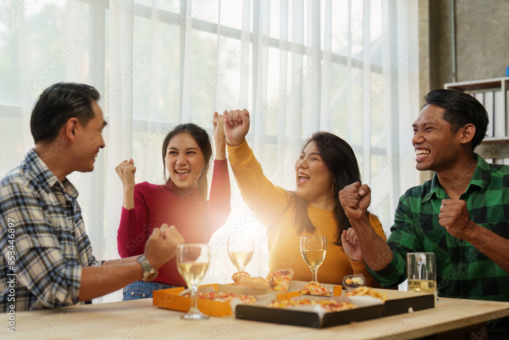 Friends at birthday party clinking glasses with champagne and pizza, enjoying Christmas vacation, pizza on the table. Holiday Party event. Friends at birthday party clinking glasses with champagne and pizza, enjoying Christmas vacation, pizza on the table. Holiday Party event.