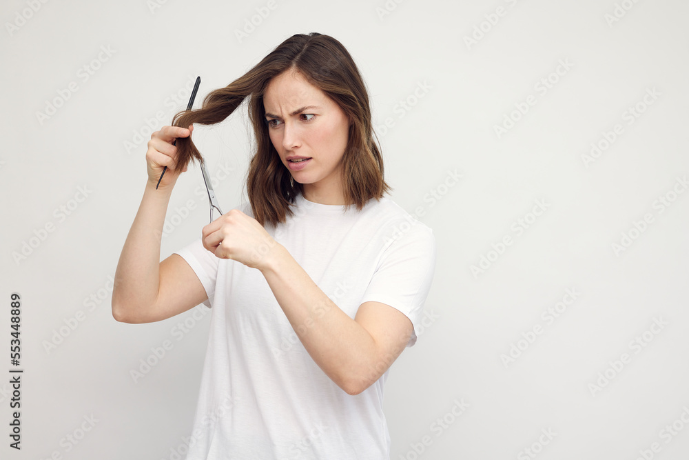 Portrait of brunette woman and hairdresser, haircut at her own hair. Portrait of brunette woman and hairdresser, haircut at her own hair.