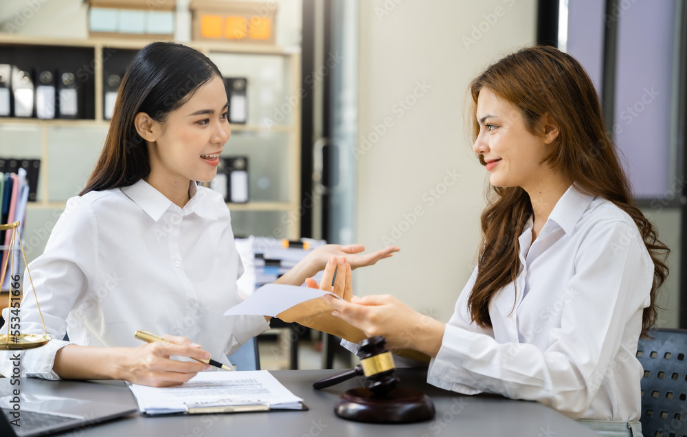 lawyers team discussing contract papers sitting in the table at office in the morning. concepts of law, advice, legal services. lawyers team discussing contract papers sitting in the table at office in the morning. concepts of law, advice, legal services.