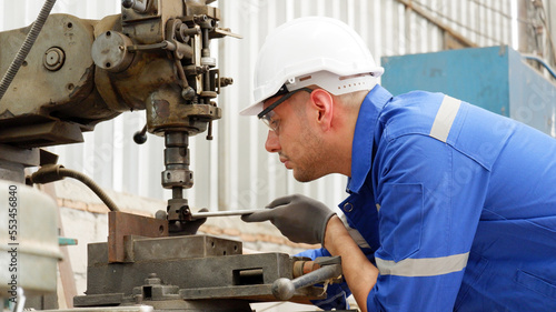 Male engineer repairing machinery industry concept.