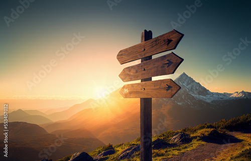 wooden signpost in the mountain at sunset
