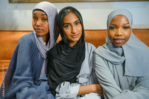 Canvas Print Portrait of three Muslim women at home