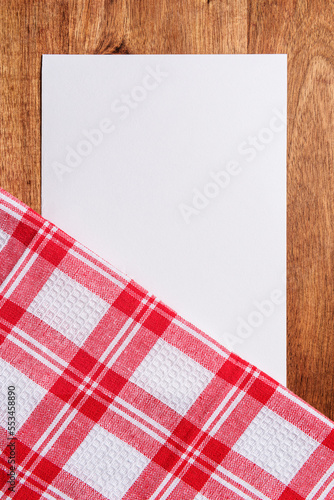 white paper and checkered cloth on wood