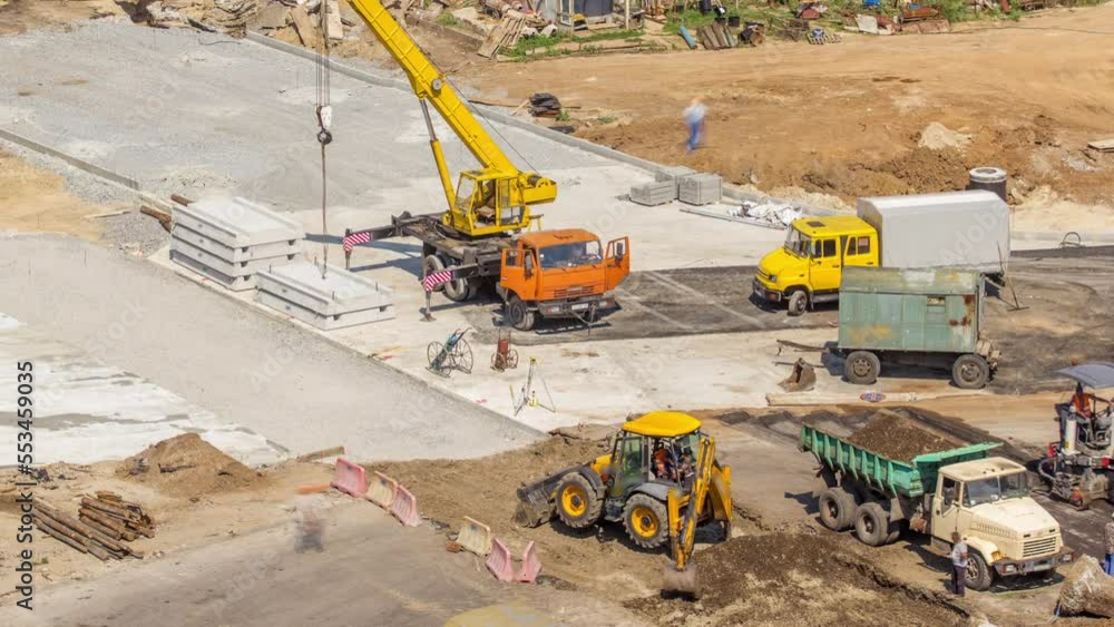 Aerial view of large road construction site with several industrial machines timelapse. Earthmoving equipment. Excavator loading soil into truck. Aerial view of large road construction site with several industrial machines timelapse. Earthmoving equipment. Excavator loading soil into truck.