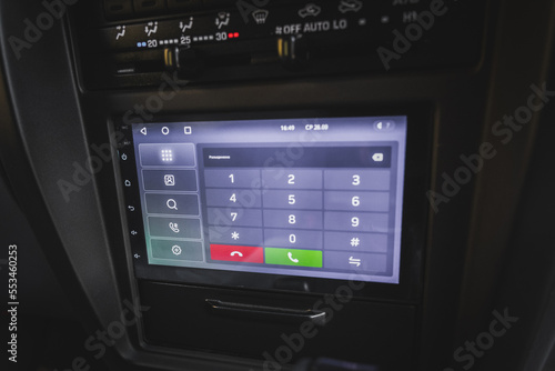 Screen on the center console of the car with telephone dialing.