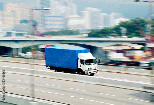 Container truck motion blur on highway overpass