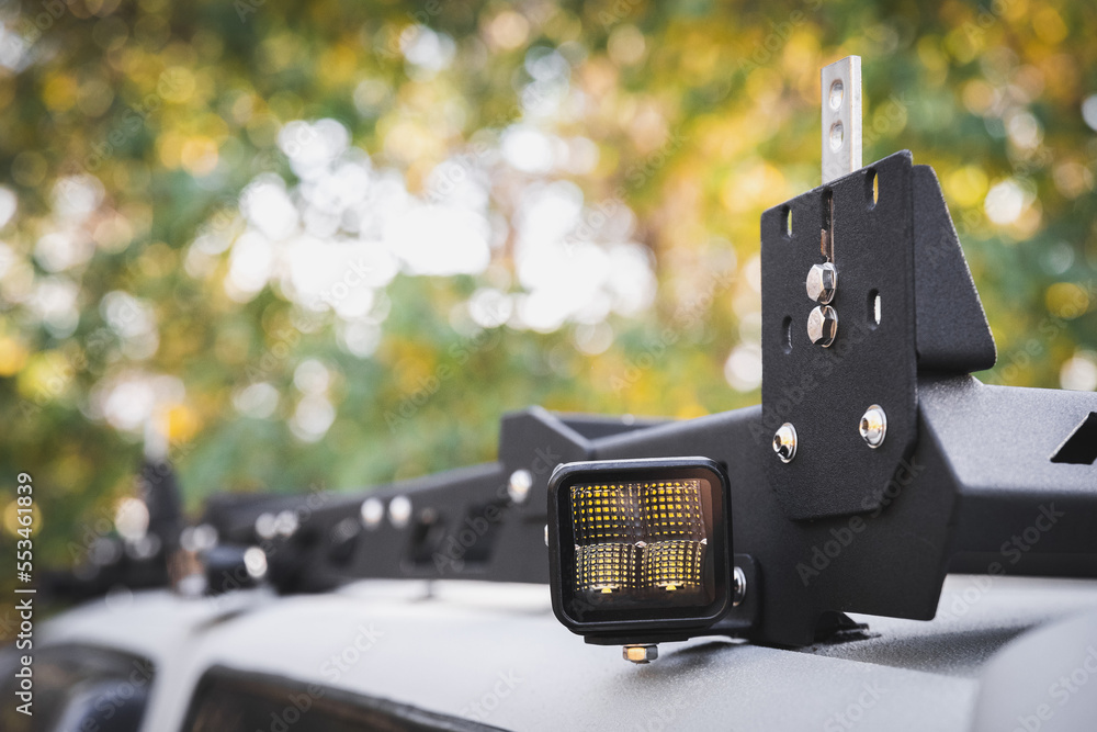 Custom LED side light bar on roof rack off road car, copy space. foto