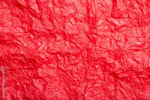 Empty red crumpled silk paper background, lot of copy space. Studio shot.