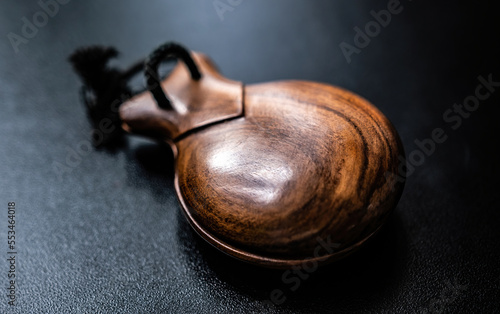 Wooden castanet for flamenco dance closeup. Traditional hispanic musical instrument for live perfomance photo