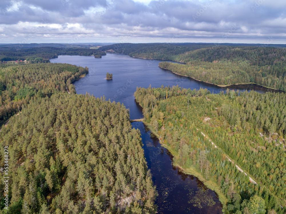 aerial footage couple Kayaking Boat tour on lake Ragnerudssjoen in Dalsland Sweden beautiful nature forest pinetree