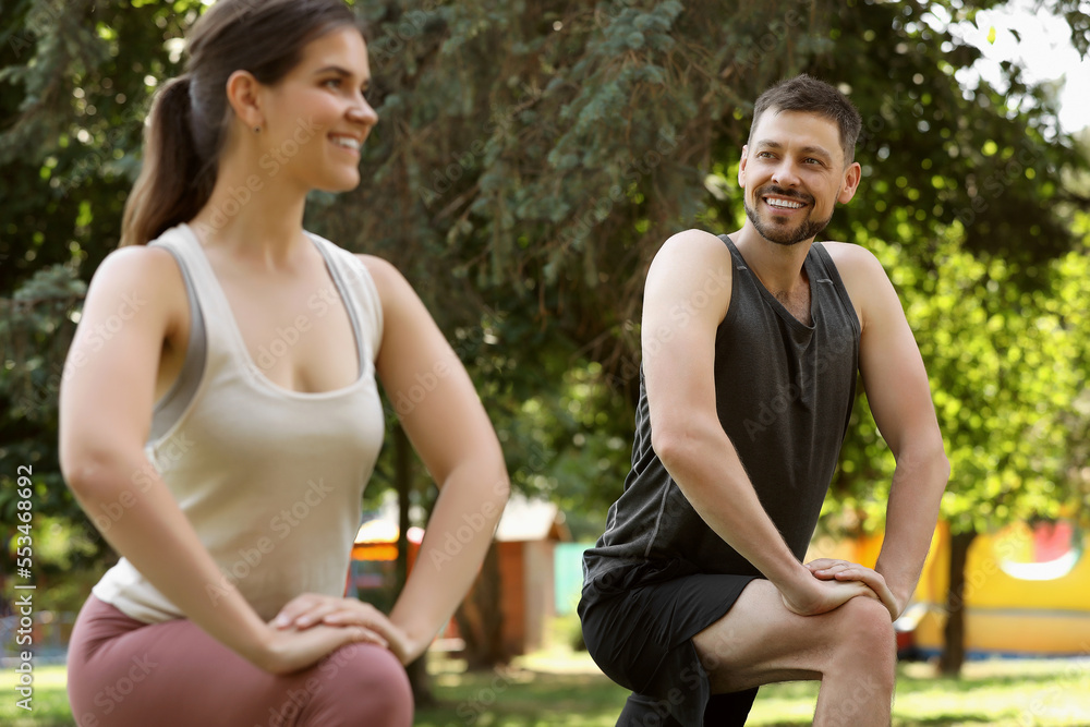 Man and woman doing morning exercise in park Man and woman doing morning exercise in park