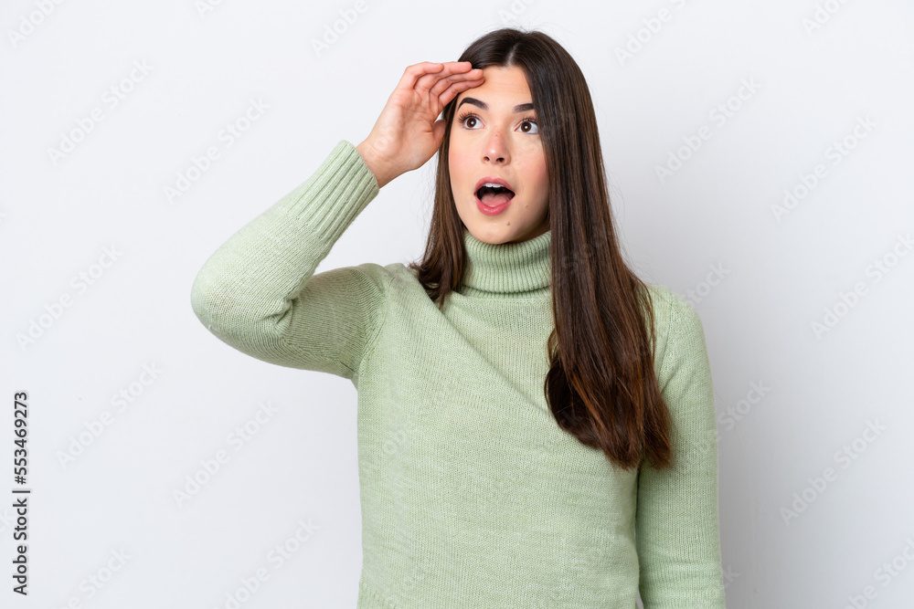 Young Brazilian woman isolated on white background with surprise expression while looking side Young Brazilian woman isolated on white background with surprise expression while looking side