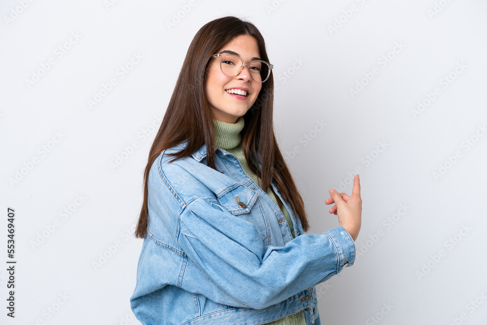 Young Brazilian woman isolated on white background pointing back Young Brazilian woman isolated on white background pointing back