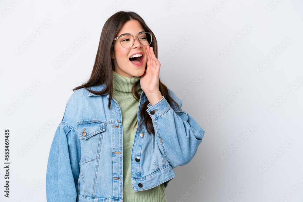 Young Brazilian woman isolated on white background shouting with mouth wide open to the side Young Brazilian woman isolated on white background shouting with mouth wide open to the side