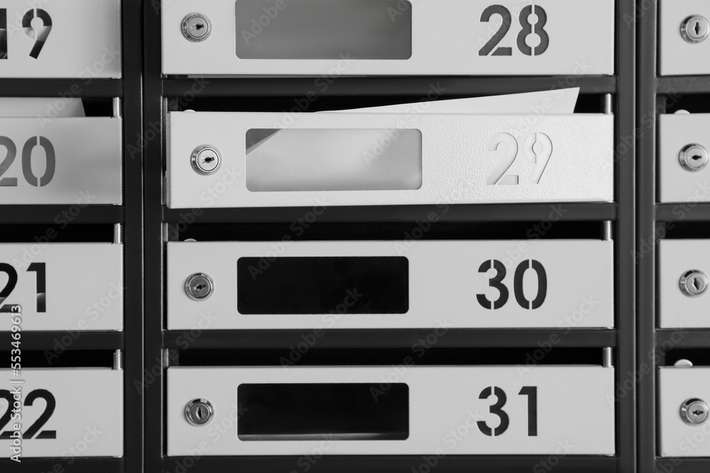 New mailboxes with keyholes, numbers and receipts as background New mailboxes with keyholes, numbers and receipts as background
