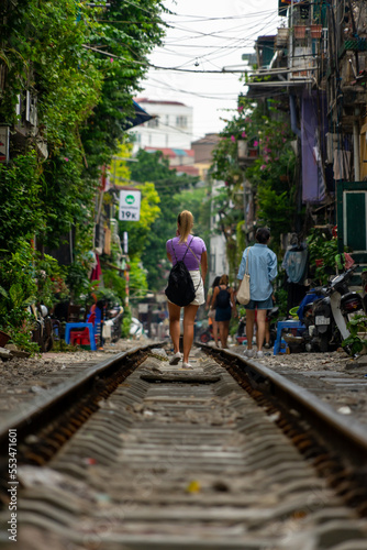 Traveler woman in Hanoi, Vietnam. Travelers around the world. Portrait of a woman on the train tracks.