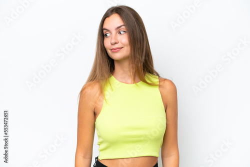 Young caucasian woman isolated on white background making doubts gesture looking side