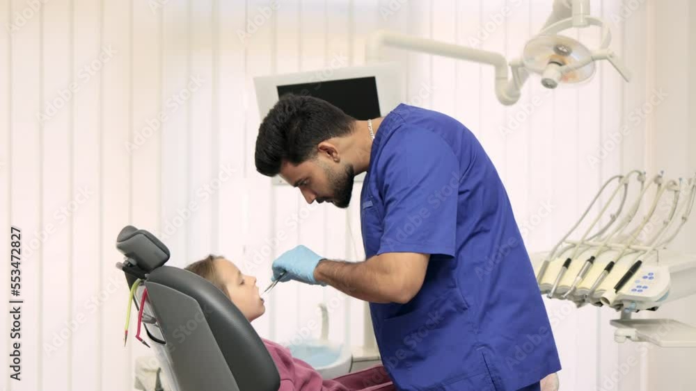Side view of smiling male professional doctor in blue uniform and ...