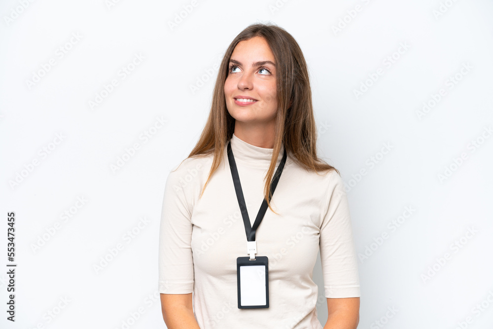 Young pretty woman with ID card isolated on white background thinking an idea while looking up