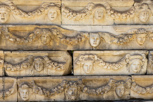 Friezes and sculpted greek masks of the Portico of Tiberius in Aphrodisias ancient city. Ruins of the theater of Afrodisias, Geyve, Aydın, Turkey.