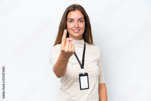 Young pretty woman with ID card isolated on white background doing coming gesture