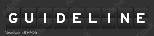 Black color analog flip board with word guideline on gray background