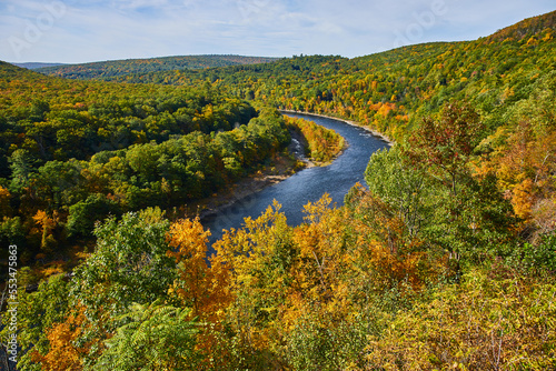 Beautiful Delaware River winding through lush green forest in early fall