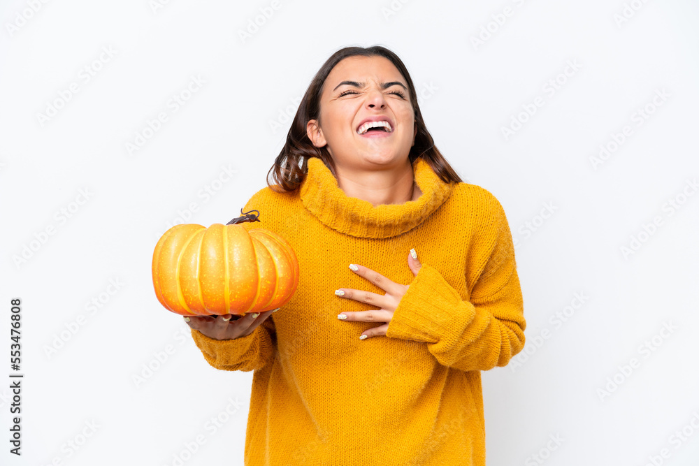 Young caucasian woman holding a pumpkin isolated on white background smiling a lot Young caucasian woman holding a pumpkin isolated on white background smiling a lot