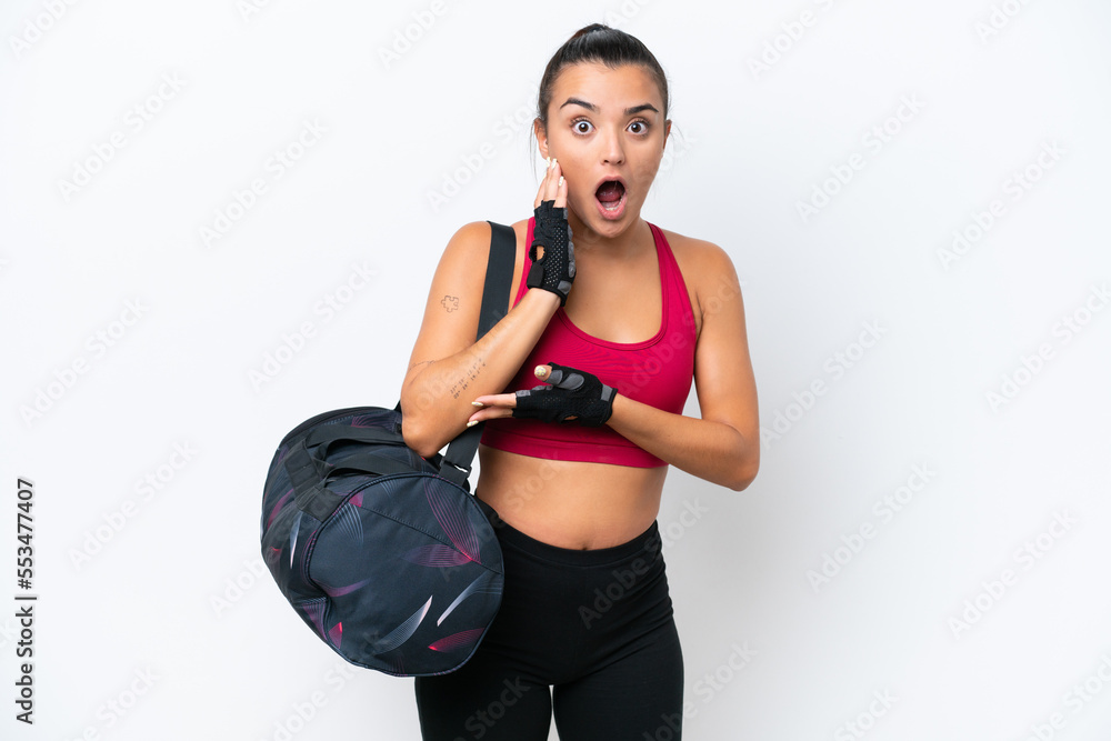 Young sport woman with sport bag isolated on white background surprised and shocked while looking right Young sport woman with sport bag isolated on white background surprised and shocked while looking right