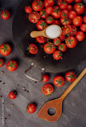 Cherry tomatoes on against black stone surface