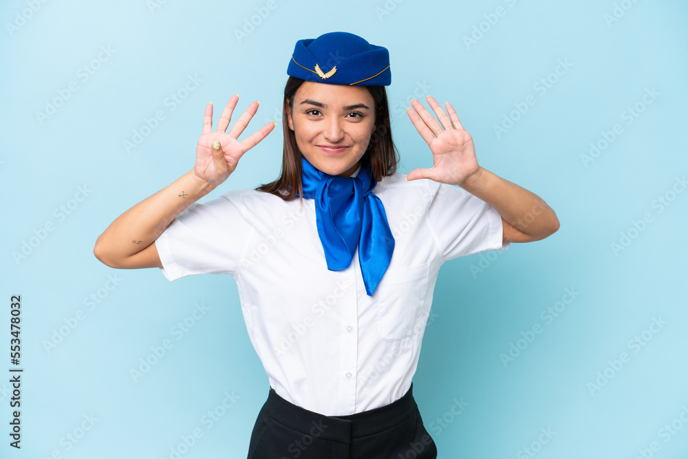Airplane stewardess caucasian woman isolated on blue background counting nine with fingers Airplane stewardess caucasian woman isolated on blue background counting nine with fingers