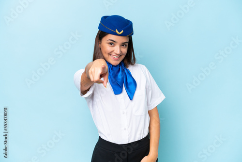 Airplane stewardess caucasian woman isolated on blue background points finger at you with a confident expression