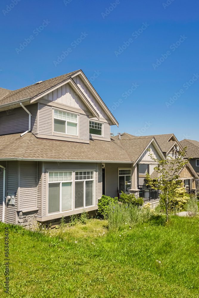 Suburban residential house with green lawn in front