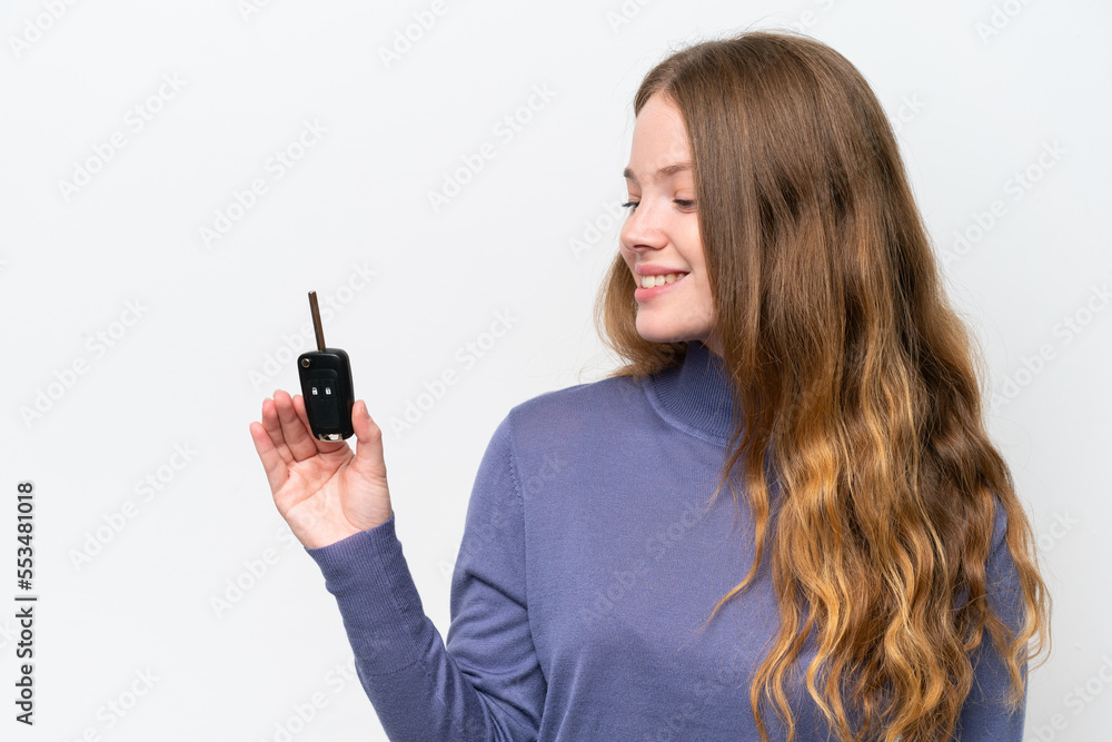 Young caucasian woman holding car keys isolated on white background with happy expression Young caucasian woman holding car keys isolated on white background with happy expression